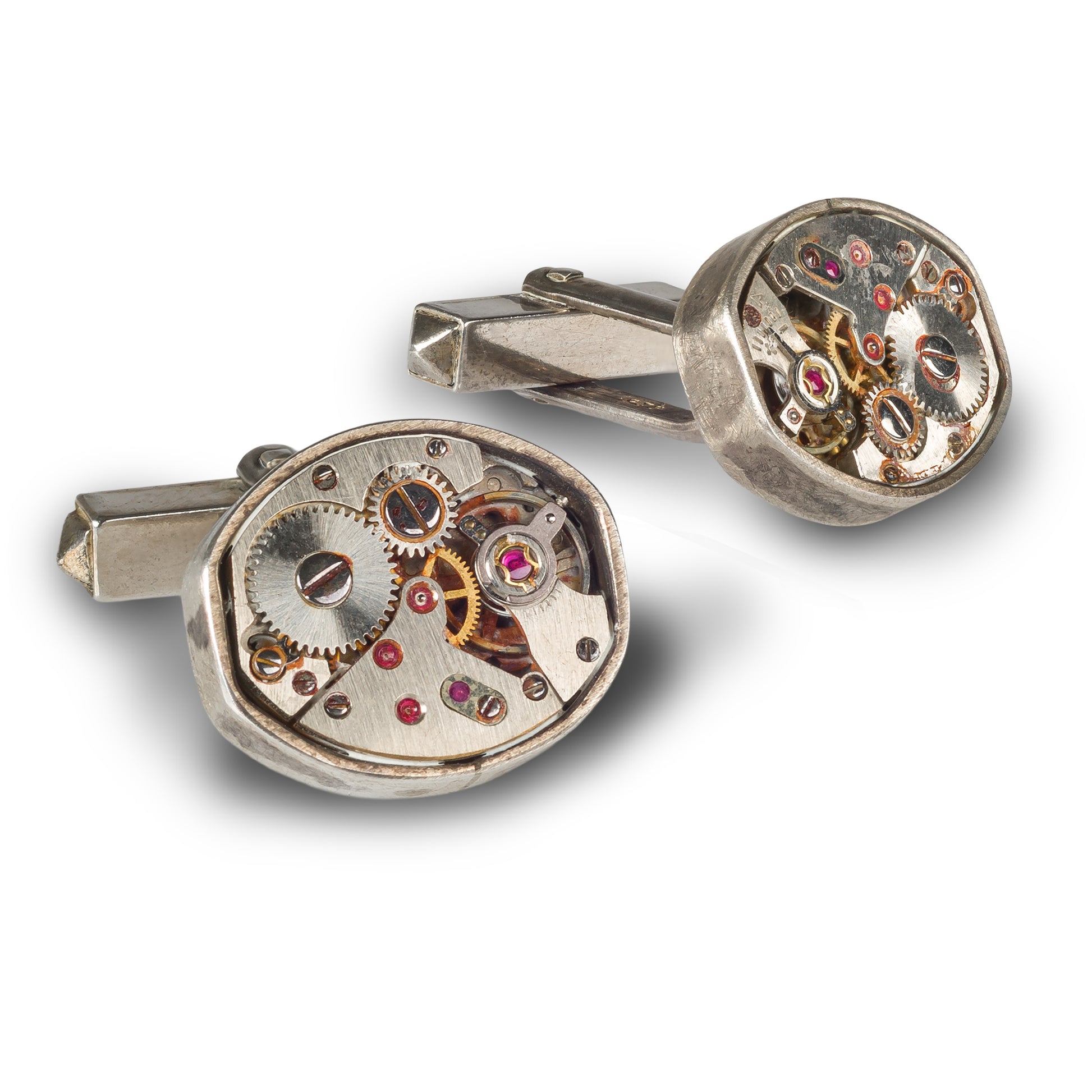 Handgefertigte Manschettenknöpfe aus Silber mit sichtbarem Vintage-Uhrwerk, fotografiert in Nahaufnahme